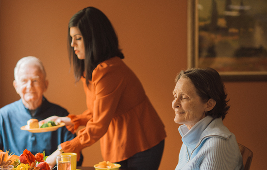 amenities-youll-love-2 Senior residents being served lunch at Summerfield of Redlands Memory Care in Redlands, CA